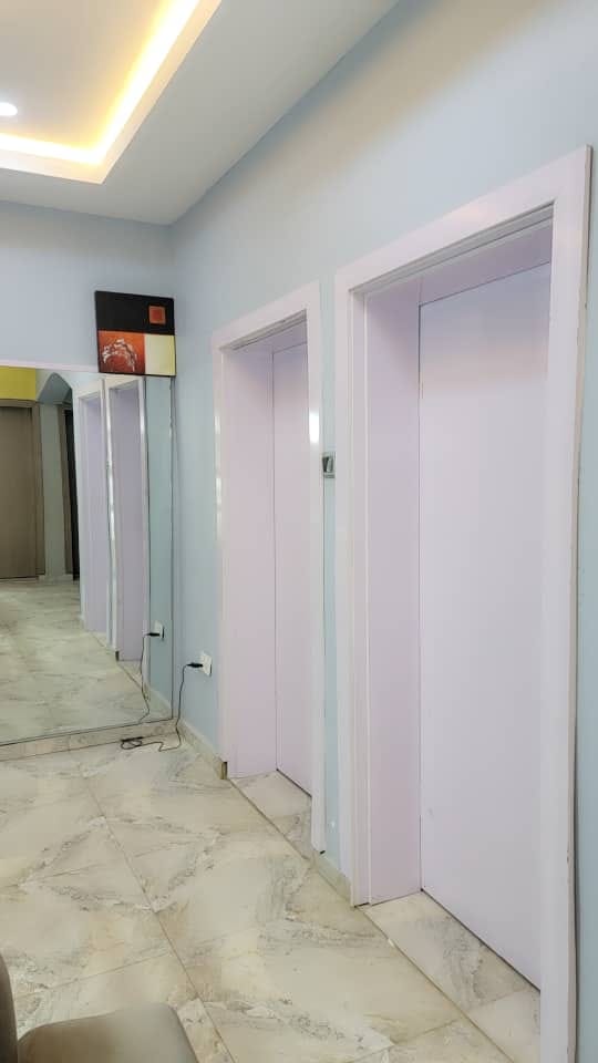 Bright hotel hallway with clean tiled flooring