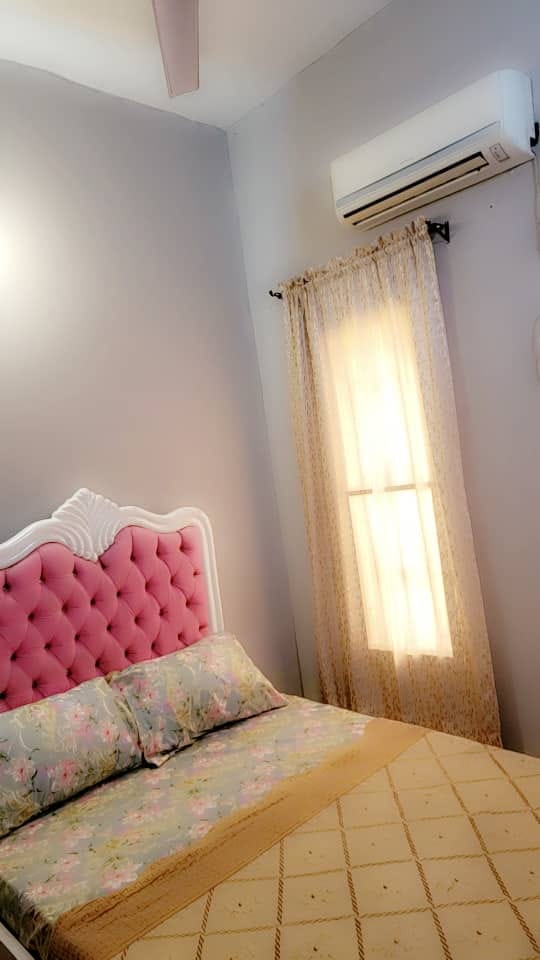 Furnished room with pink headboard, window, and air conditioning
