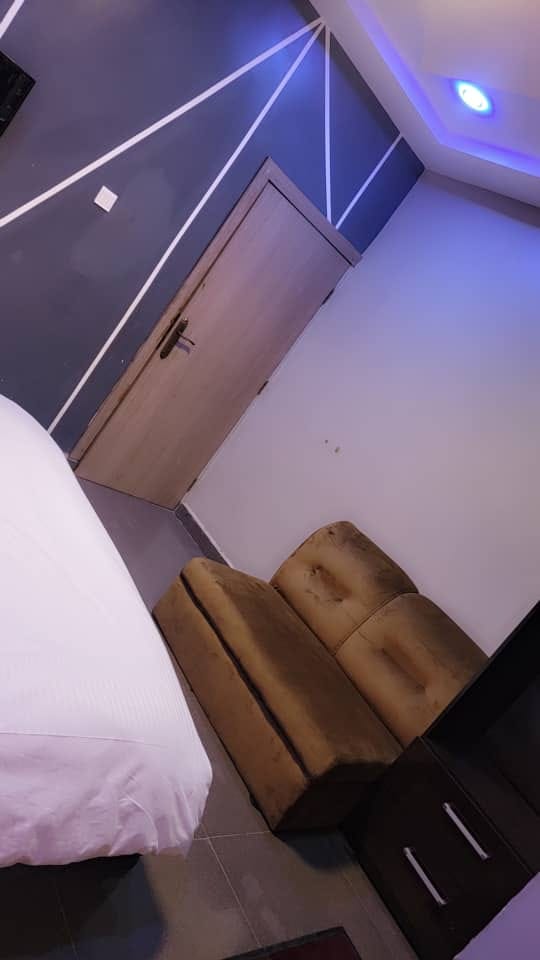 Guest room with sofa seating and modern wall design