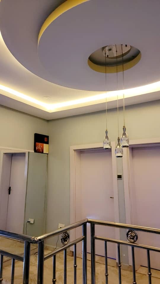 Upper hall with pendant lighting and polished railings