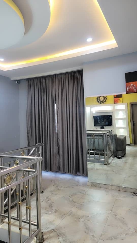 Upper landing with polished railings and modern ceiling lighting